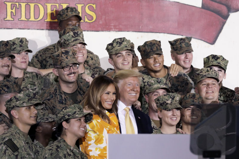 US President Donald Trump and First Lady Melania Trump pose for a photograph with US military personnel aboard the USS <em>Wasp</em> aircraft carrier at the US naval base in Yokosuka, Kanagawa Prefecture, Japan, on Tuesday, May 28, 2019. Trump told troops stationed in Japan he plans to order traditional steam-powered catapults aboard American warships instead of newer electromagnetic systems that he said may not work as well during wartime. 