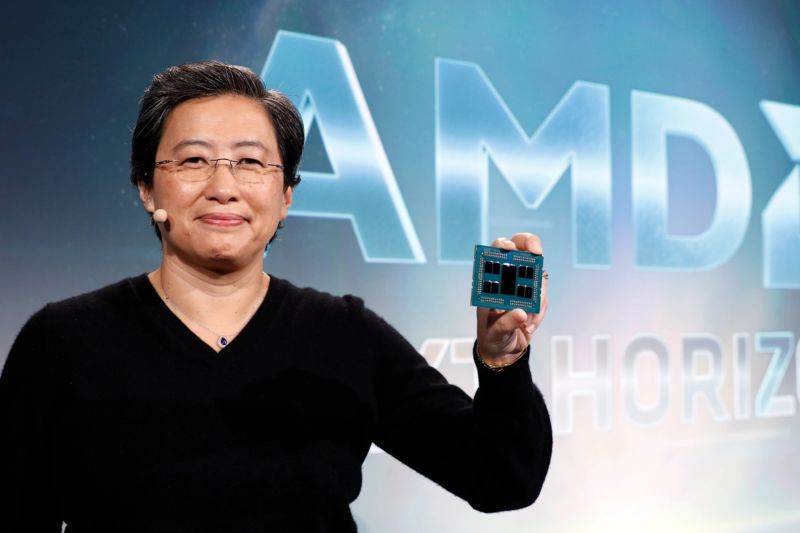 AMD CEO Lisa Su, holding a Rome processor. The large chip in the middle is the 14nm I/O chip; around it are pairs of 7nm chiplets containing the CPU cores.