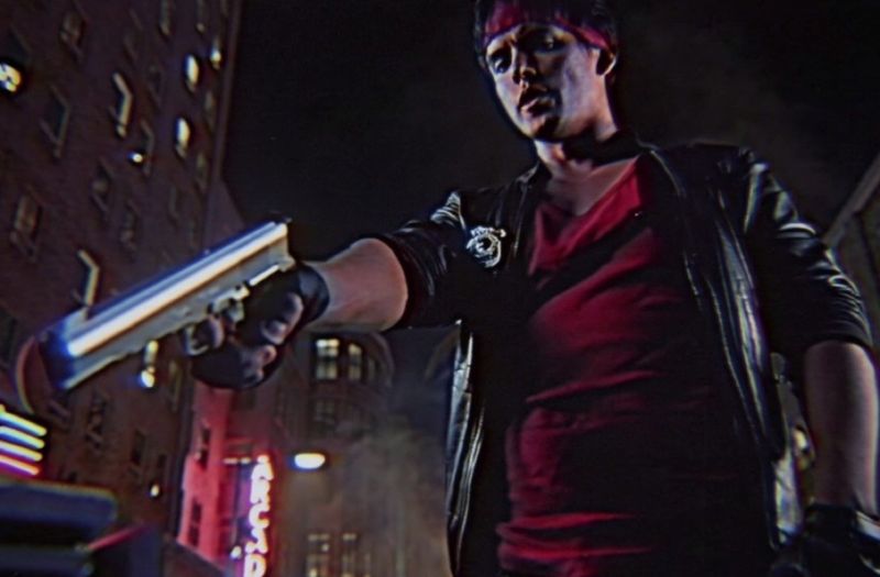 Screenshot from short film shows a cool guy pointing a handgun.