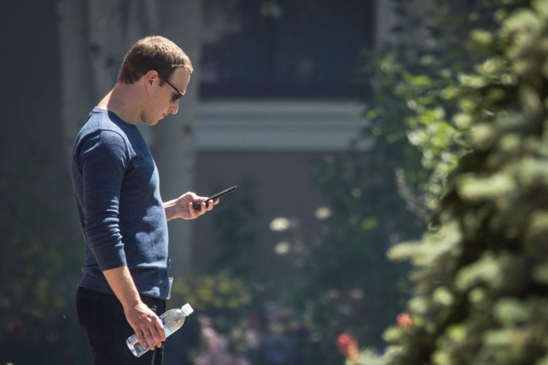 Facebook CEO Mark Zuckerberg checks his phone during the annual Allen & Company Sun Valley Conference, July 13, 2018 in Sun Valley, Idaho. 