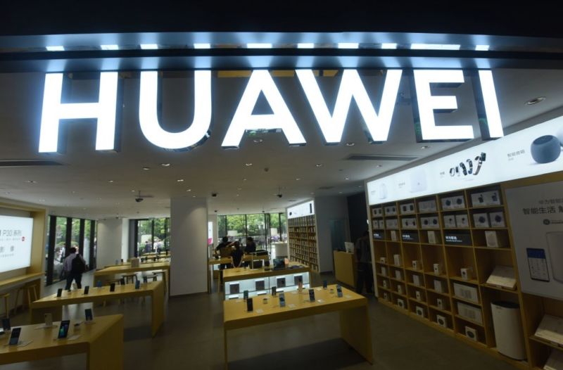 Customers purchase mobile phones at a Huawei store in China.