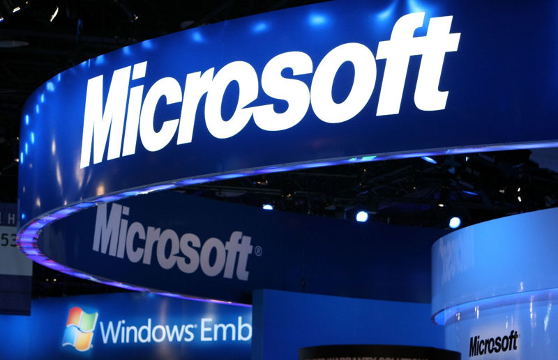 The Microsoft logo displayed at Microsoft's booth at a trade show.