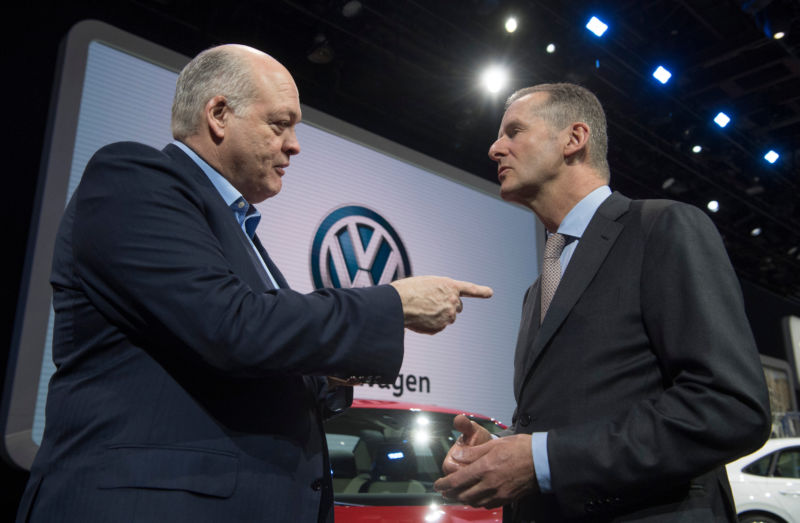 Ford CEO Jim Hackett, left, talks to Volkswagen CEO Herbert Diess in January 2019.