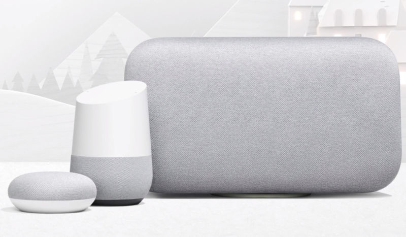 Three different Google Home smart speakers sitting next to each other on a table.