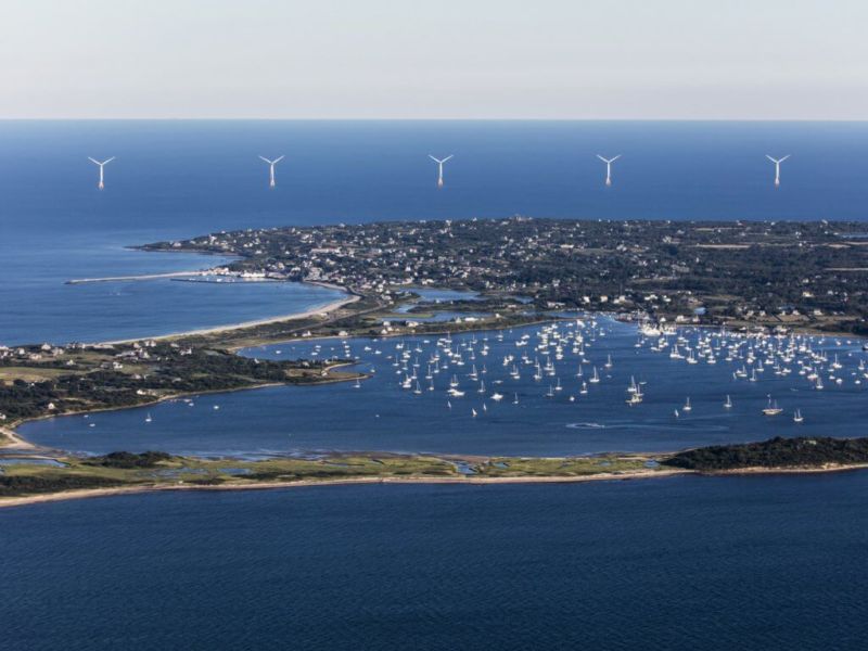 Image of wind turbines behind a large bay.