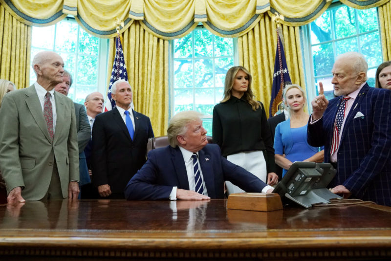 President Trump, with Apollo 11 Command Module Pilot at far left, listens to Apollo 11 Lunar Module Pilot Buzz Aldrin on Friday in the Oval Office.